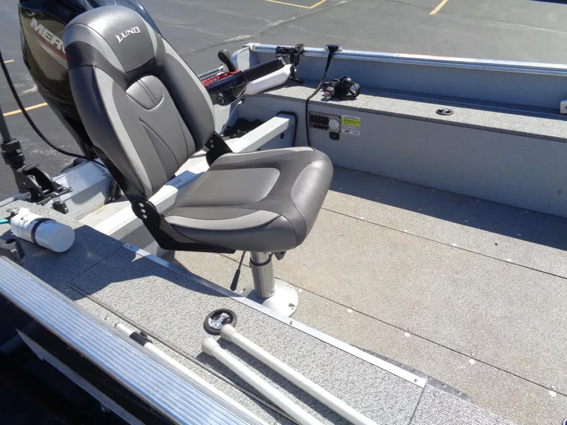 Slide: The Image of 2023 Lund 1600 Alaskan Tiller boat interior with seating and controls. - 10