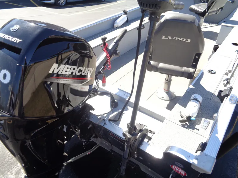 Slide: The Image of 2023 Lund 1600 Alaskan Tiller boat with Mercury engine, featuring comfortable seating. - 21