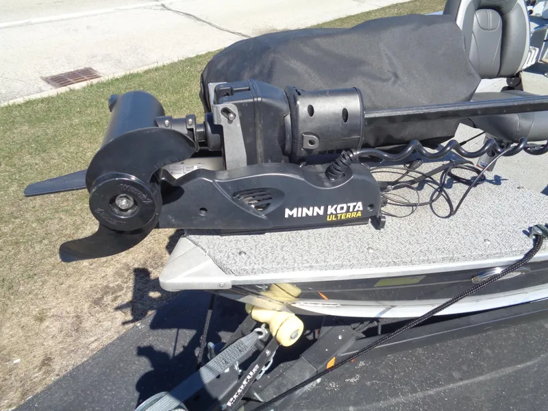 Slide: The Image of Minn Kota Ulterra motor on 2023 Lund 1600 Alaskan Tiller boat, parked on grass. - 22