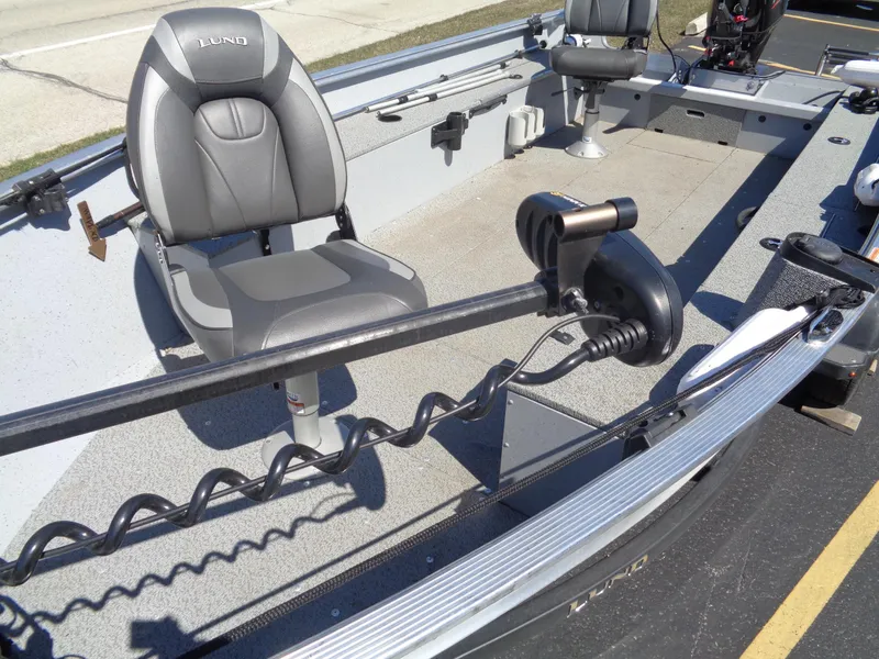 Slide: The Image of 2023 Lund 1600 Alaskan Tiller boat interior with seating and motor. - 5