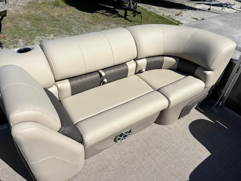 Slide: The Image of 2025 Sun Tracker Party Barge 20 DLX beige seating, outdoor setting, comfortable and spacious design. - 11