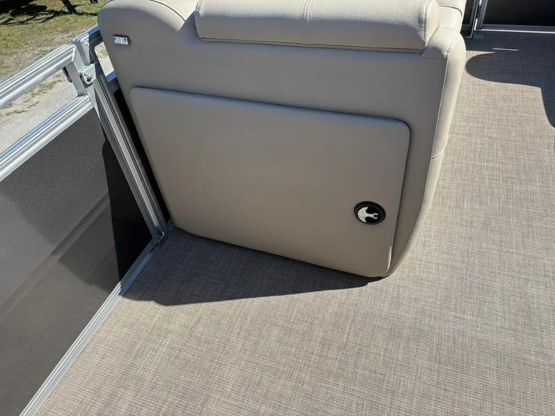 Slide: The Image of 2025 Sun Tracker Party Barge 20 DLX interior with beige seating and carpeted flooring. - 15