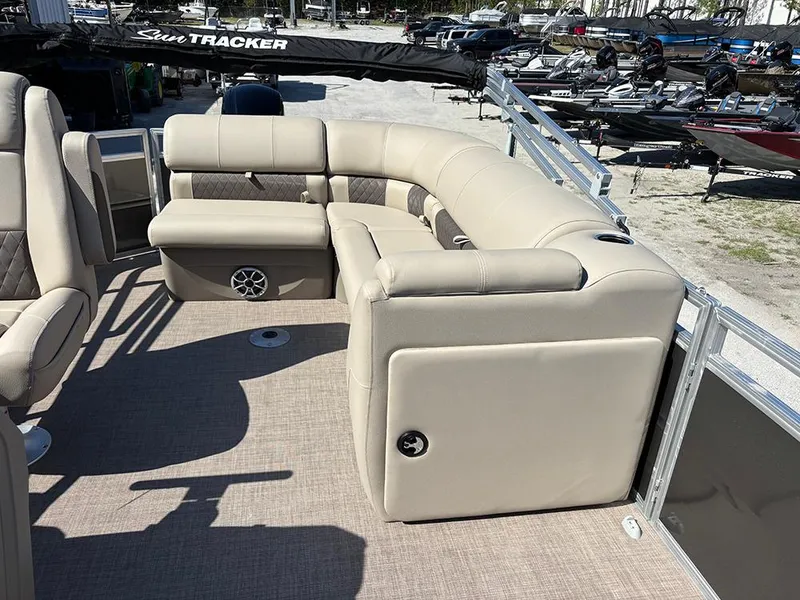 Slide: The Image of 2025 Sun Tracker Party Barge 20 DLX with beige seating and spacious deck layout. - 17