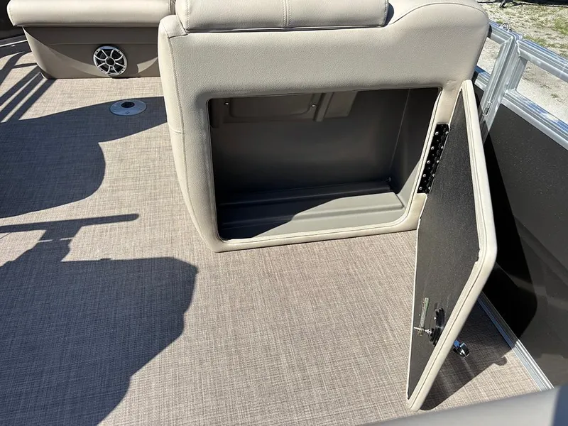 Slide: The Image of 2025 Sun Tracker Party Barge 20 DLX interior storage compartment with open door. - 18