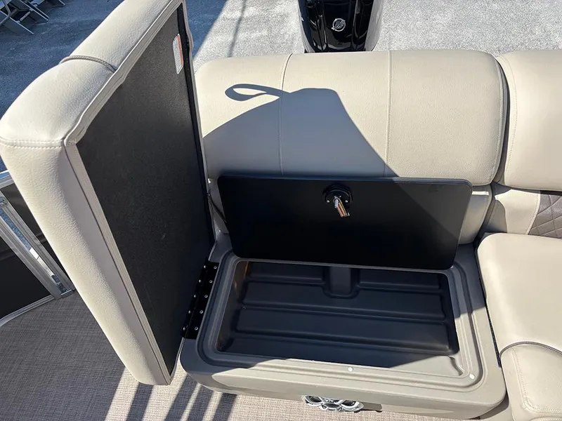 Slide: The Image of 2025 Sun Tracker Party Barge 20 DLX storage compartment with open seat lid. - 22