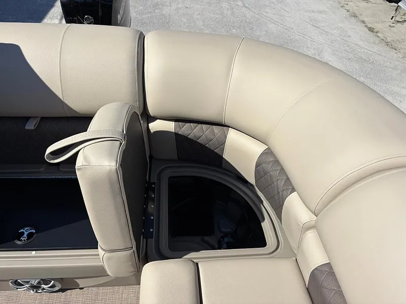 Slide: The Image of 2025 Sun Tracker Party Barge 20 DLX seating area with storage compartment. - 24