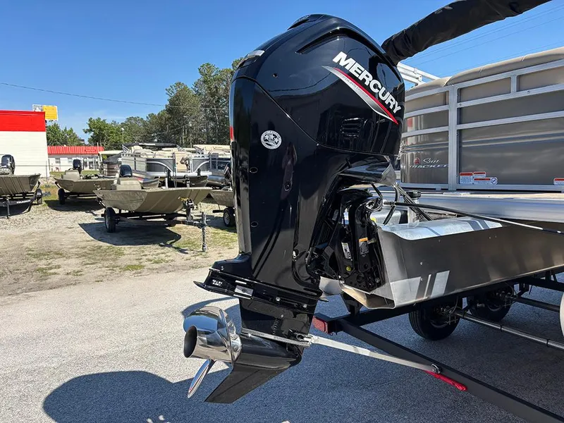Slide: The Image of 2025 Sun Tracker Party Barge 20 DLX with Mercury outboard motor in a boatyard. - 27