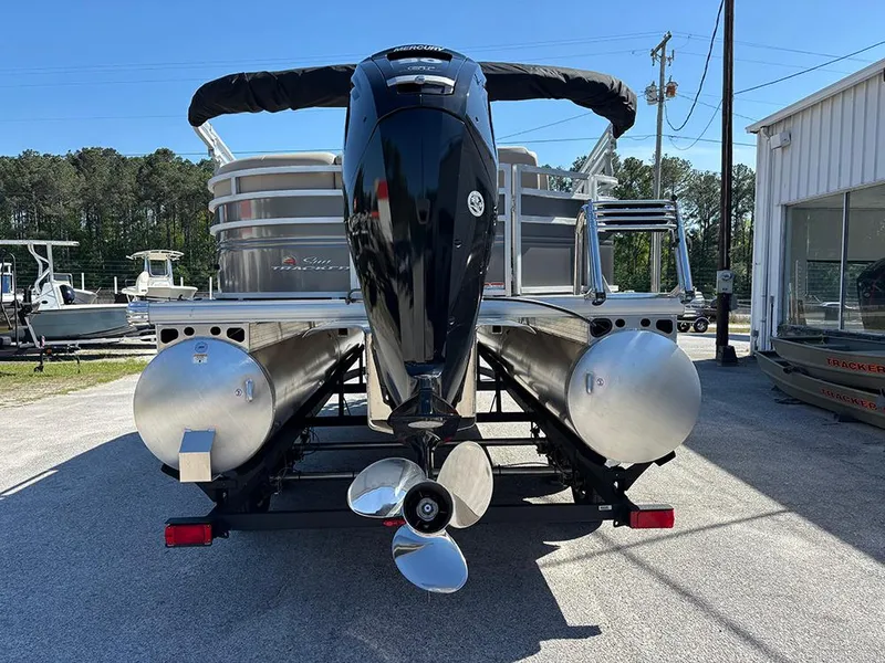 Slide: The Image of 2025 Sun Tracker Party Barge 20 DLX pontoon boat, rear view with motor and pontoons. - 7