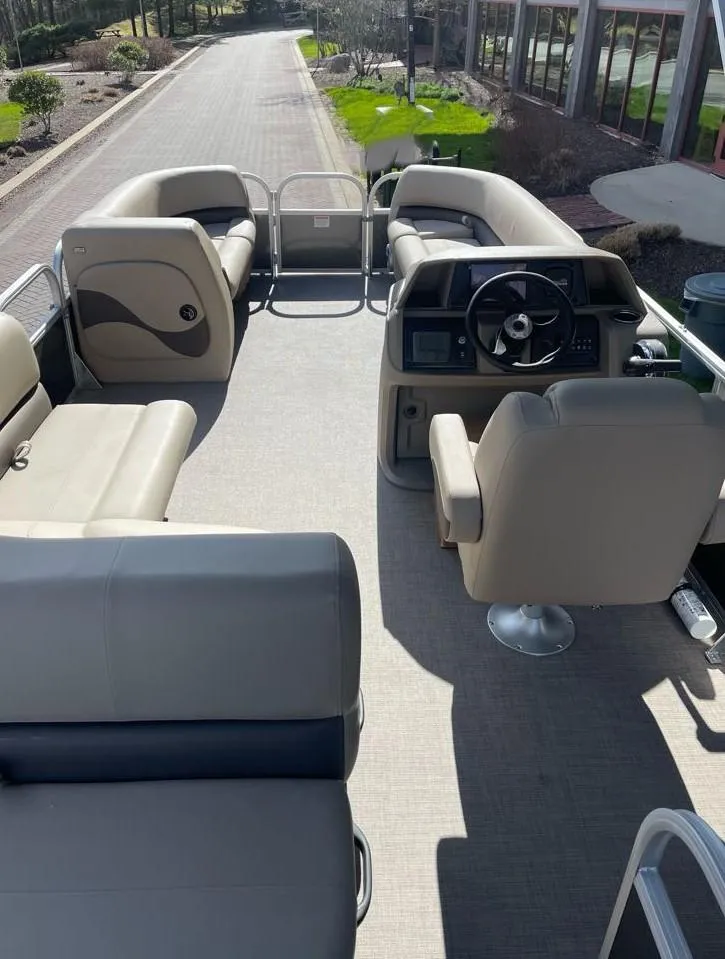 Slide: The Image of 2025 Sun Tracker Party Barge 18 DLX interior with seating and steering console. - 5