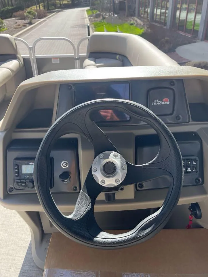 Slide: The Image of 2025 Sun Tracker Party Barge 18 DLX steering console with modern controls and dashboard. - 6