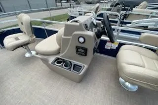 Slide: The Image of 2025 Sun Tracker Bass Buggy 16 XL Select pontoon boat interior with beige seating. - 3