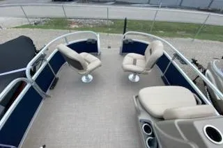Slide: The Image of 2025 Sun Tracker Bass Buggy 16 XL Select pontoon boat interior with seating and console. - 5