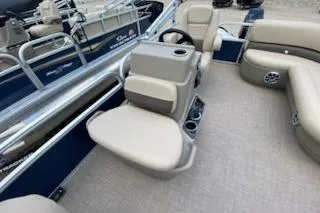 Slide: The Image of 2025 Sun Tracker Bass Buggy 16 XL Select pontoon boat interior with beige seating and steering console. - 7