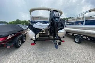 Slide: The Image of 2025 Sun Tracker Bass Buggy 16 XL Select pontoon boat on a trailer, rear view. - 9