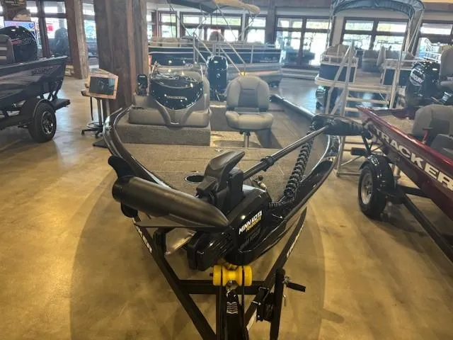 Slide: The Image of 2025 Tracker Super Guide V-16 SC boat displayed in a showroom. - 2