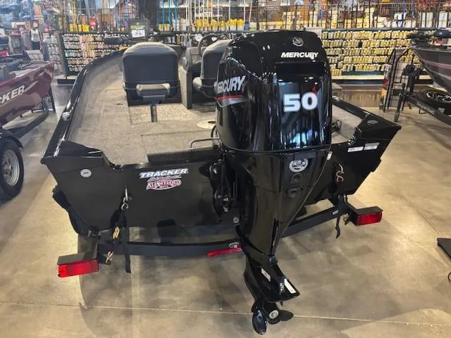 Slide: The Image of 2025 Tracker Super Guide V-16 SC boat with Mercury 50 outboard motor in showroom. - 3