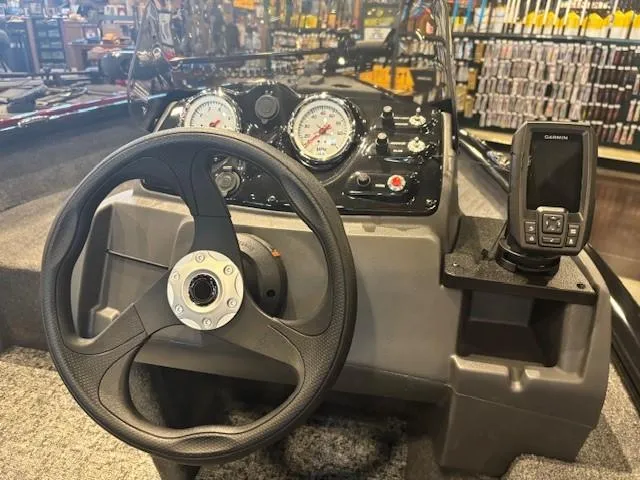 Slide: The Image of 2025 Tracker Super Guide V-16 SC boat dashboard with steering wheel and Garmin device. - 4