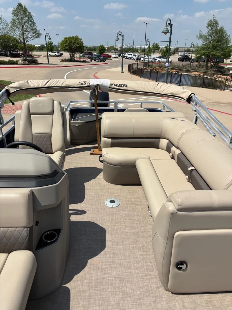 Slide: The Image of 2025 Sun Tracker Fishin' Barge 20 DLX with beige seating and spacious deck. - 2
