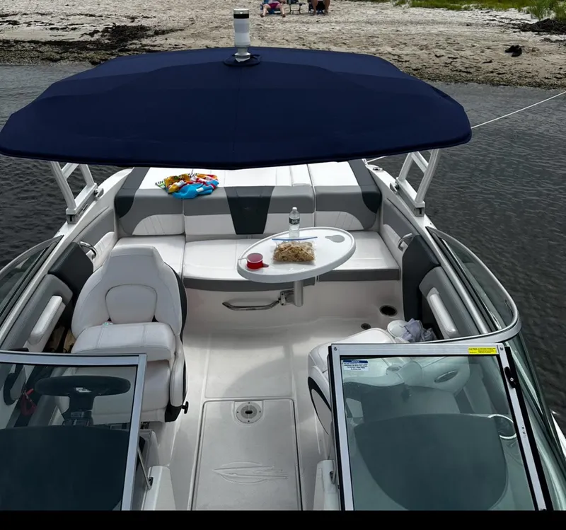 Slide: The Image of 2021 Chaparral 21 SSi OB boat interior with seating, table, and canopy. - 11