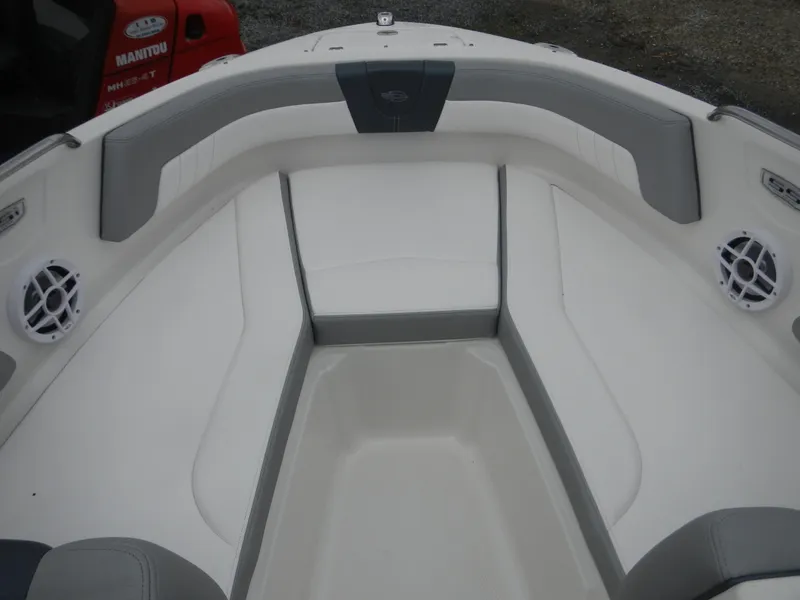 Slide: The Image of 2021 Chaparral 21 SSi OB boat interior with cushioned seating and speakers. - 16
