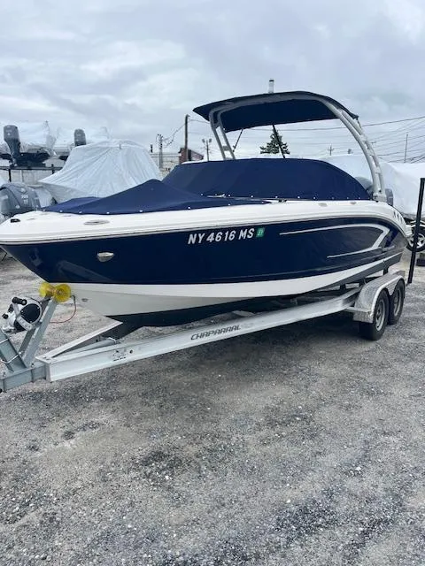 Slide: The Image of 2021 Chaparral 21 SSi OB boat on trailer, covered, parked outdoors. - 2