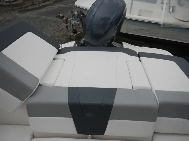 Slide: The Image of 2021 Chaparral 21 SSi OB boat with gray and white seating and outboard motor. - 20