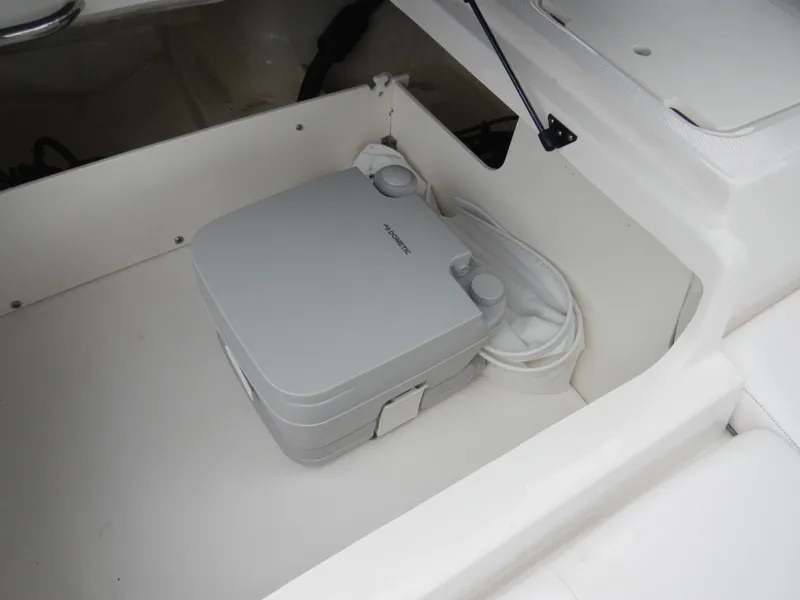 Slide: The Image of Storage compartment in 2021 Chaparral 21 SSi OB boat with portable toilet. - 21