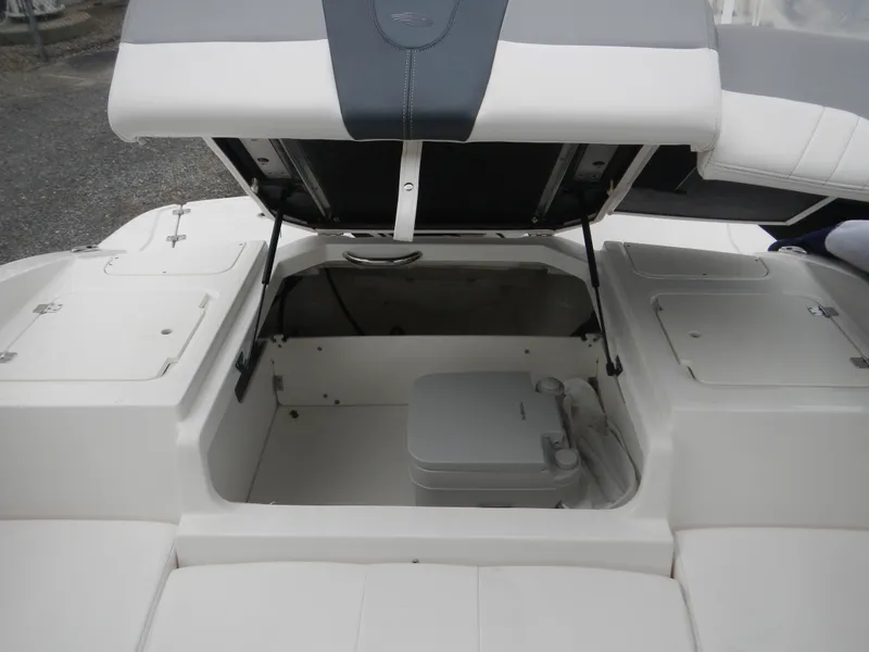 Slide: The Image of 2021 Chaparral 21 SSi OB boat storage compartment with open hatch, showcasing interior space. - 22