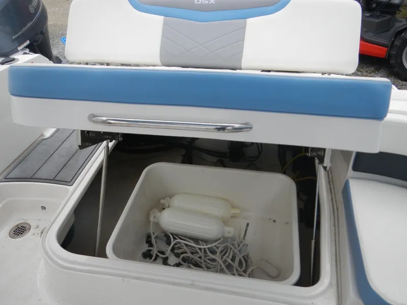 Slide: The Image of 2021 Chaparral 21 SSi OB boat storage compartment with fenders and ropes. - 30