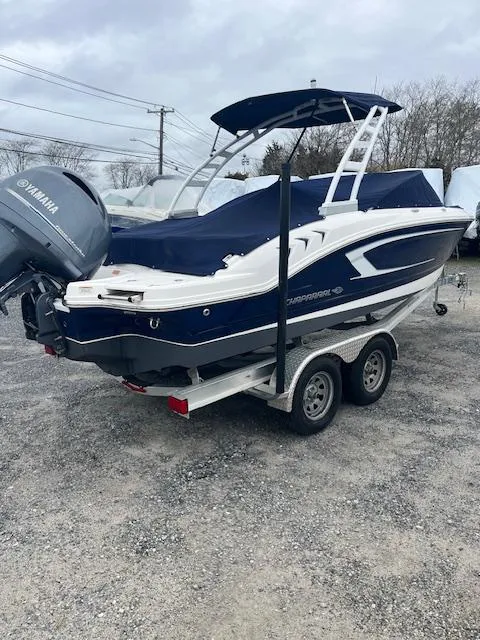 Slide: The Image of 2021 Chaparral 21 SSi OB boat on trailer, blue and white design, Yamaha outboard motor. - 6