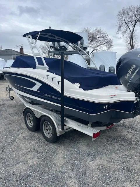 Slide: The Image of 2021 Chaparral 21 SSi OB boat with Yamaha outboard, on a trailer, covered and parked outdoors. - 7