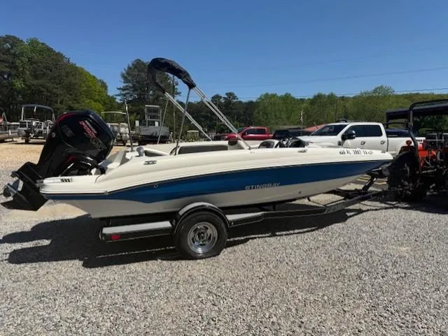 Slide: The Image of 2018 Stingray 182 SC boat on trailer, parked outdoors on gravel. - 0