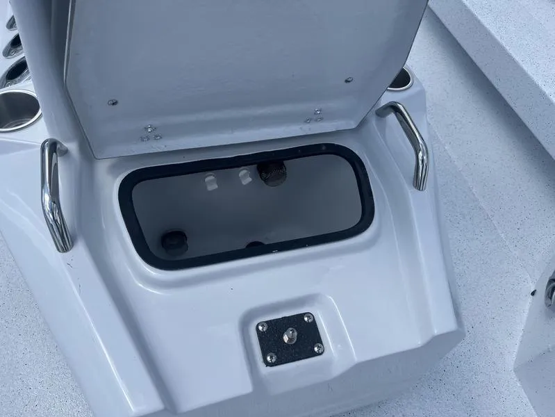 Slide: The Image of Open storage compartment on 2025 Xpress H20B boat with stainless steel handles. - 10