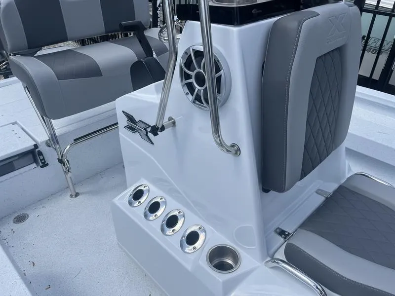 Slide: The Image of 2025 Xpress H20B boat interior with seating, speaker, and rod holders. - 11
