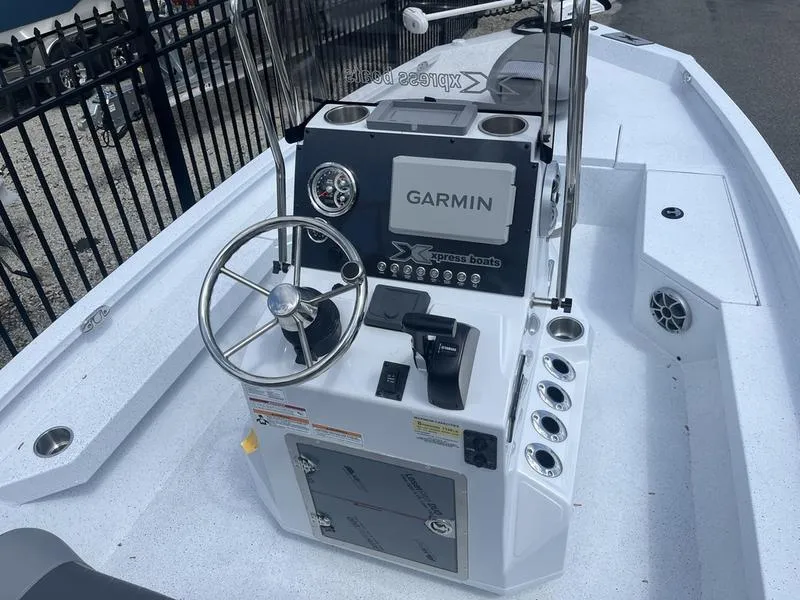 Slide: The Image of 2025 Xpress H20B boat console with Garmin system and steering wheel. - 12