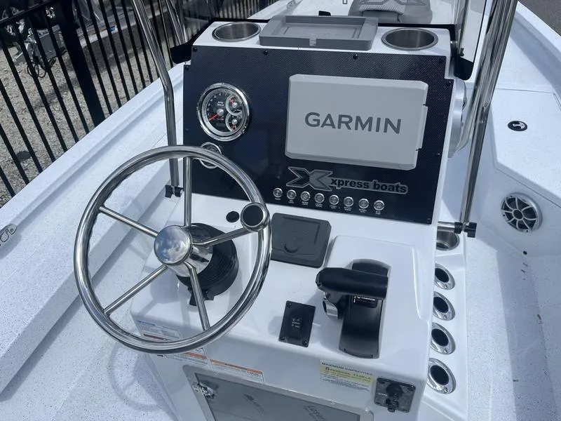 Slide: The Image of 2025 Xpress H20B boat dashboard with Garmin navigation system and steering wheel. - 13