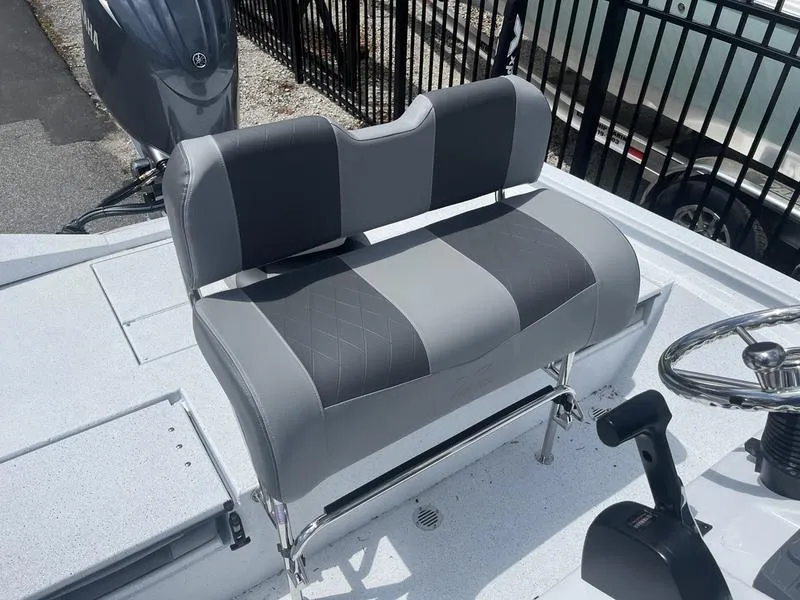 Slide: The Image of 2025 Xpress H20B boat interior with gray seating and steering wheel. - 14