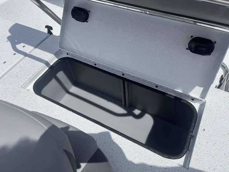 Slide: The Image of 2025 Xpress H20B boat storage compartment with open lid, showcasing interior space. - 17