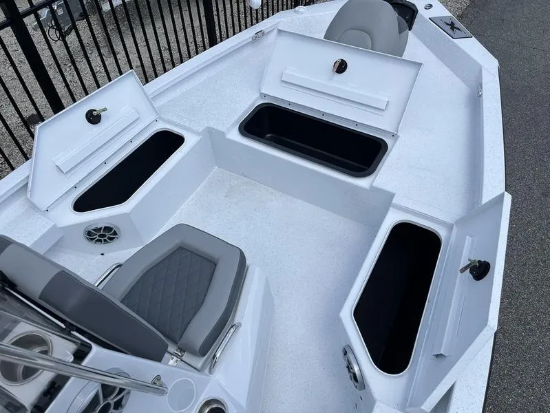 Slide: The Image of 2025 Xpress H20B boat interior with open storage compartments and seating. - 5