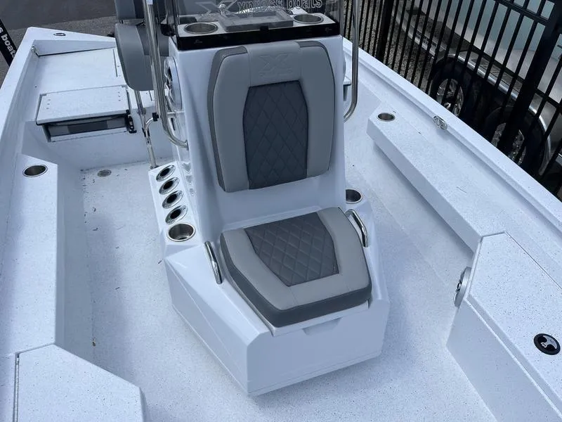 Slide: The Image of 2025 Xpress H20B boat interior with cushioned seating and storage compartments. - 8