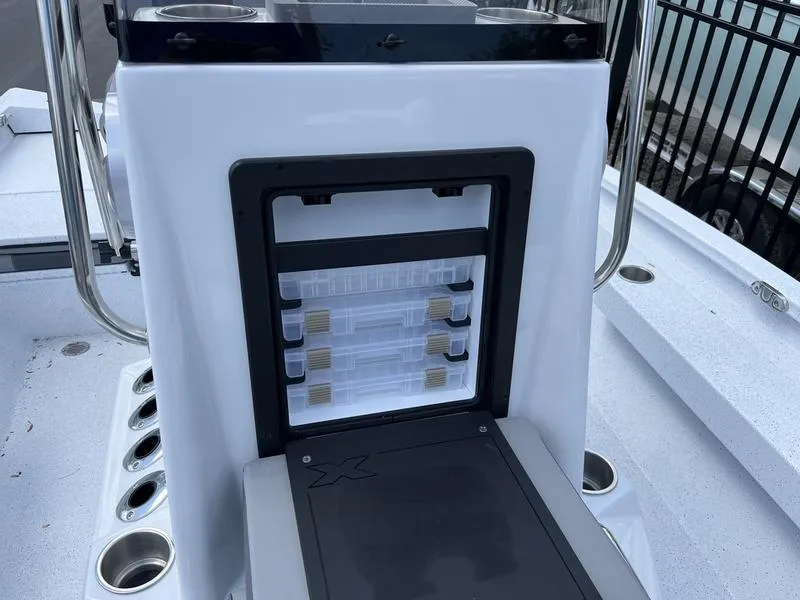 Slide: The Image of 2025 Xpress H20B boat console with storage compartments and rod holders. - 9