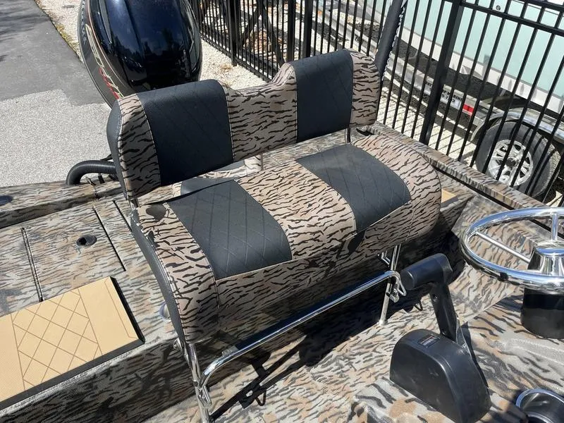 Slide: The Image of 2025 Xpress H210B boat with tiger-patterned seats and steering wheel. - 10