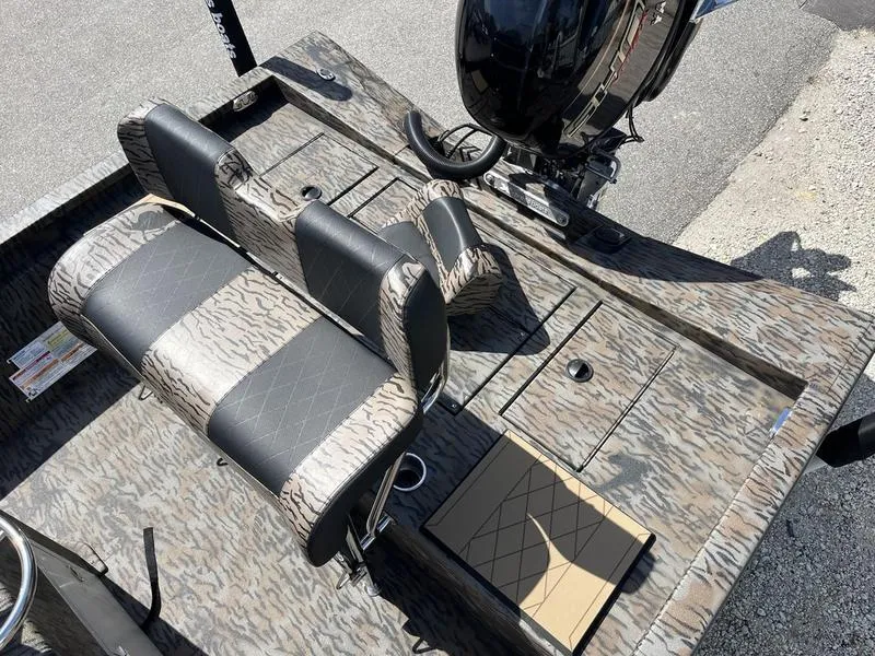 Slide: The Image of 2025 Xpress H210B boat interior with camo seats and motor, viewed from above. - 11
