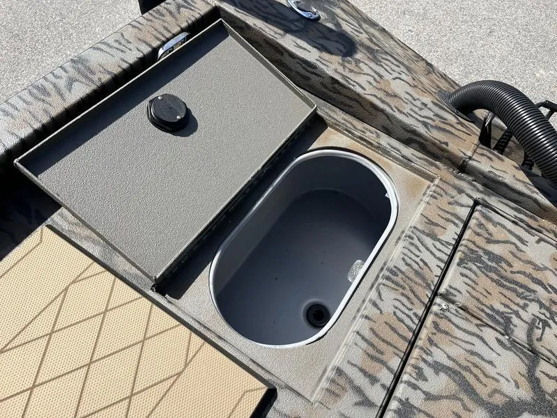 Slide: The Image of Open storage compartment on 2025 Xpress H210B boat with camouflage design. - 13