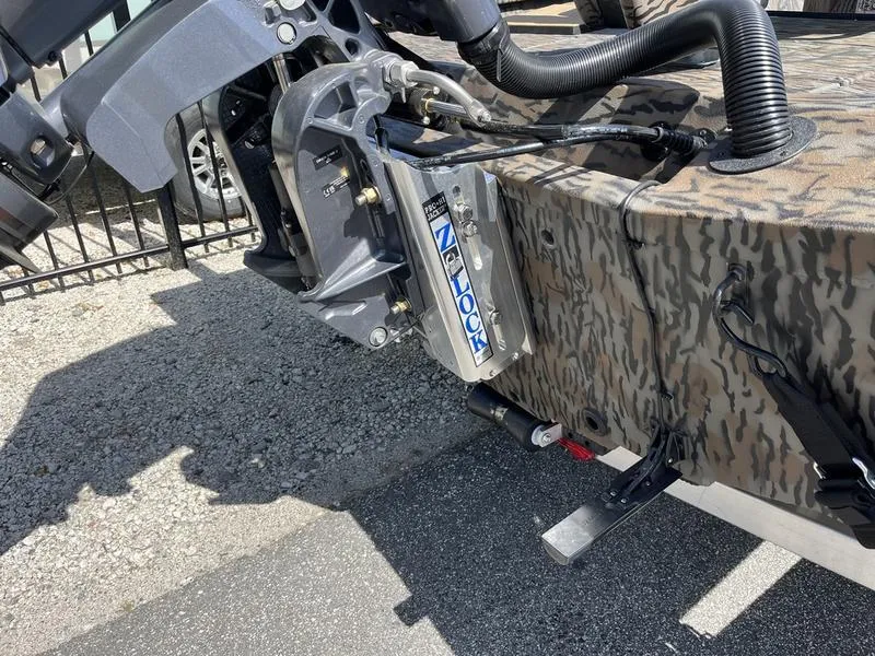 Slide: The Image of 2025 Xpress H210B boat with camo design and motor mount detail. - 14