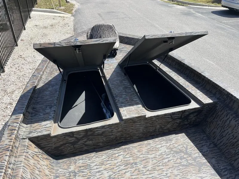 Slide: The Image of 2025 Xpress H210B boat with open storage compartments, showcasing camouflage design. - 5