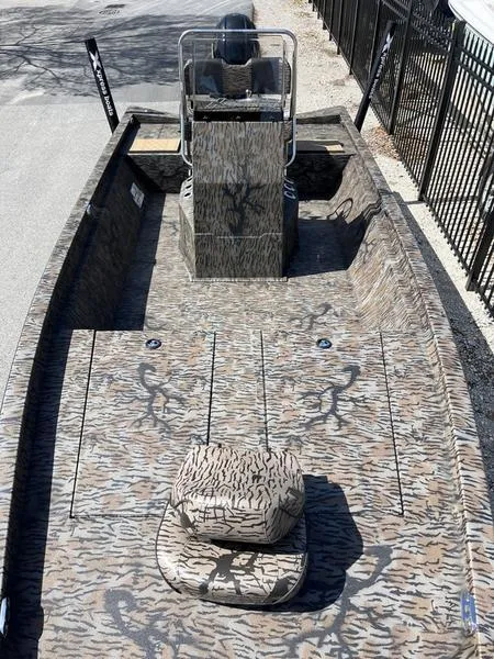 Slide: The Image of 2025 Xpress H210B boat with camouflage design, featuring spacious deck and center console. - 6