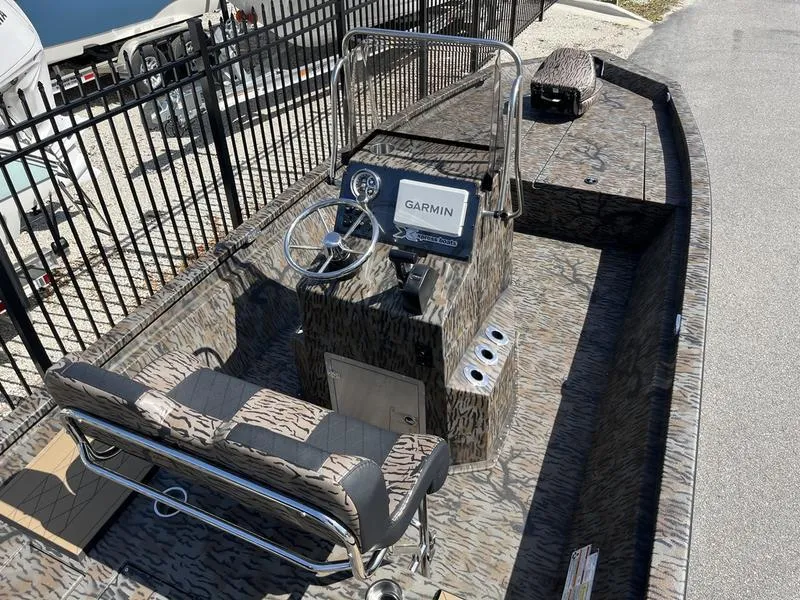 Slide: The Image of 2025 Xpress H210B boat interior with Garmin navigation system, camo design, and seating. - 8