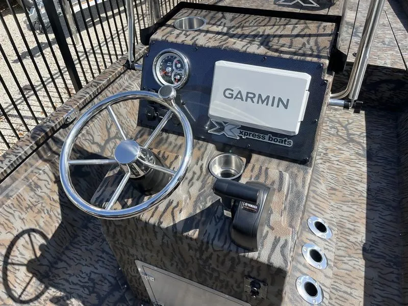 Slide: The Image of 2025 Xpress H210B boat console with Garmin navigation system and steering wheel. - 9