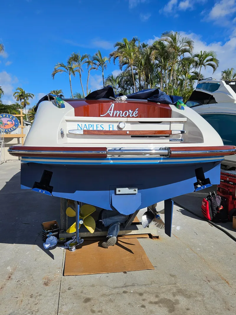 Slide: The Image of 2015 Riva Aquariva Super boat named "Amoré" in Naples, FL, docked under clear skies. - 16